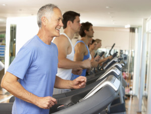 Senior Man On Running Machine In Gym